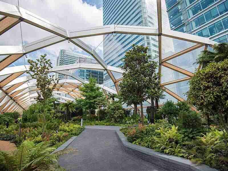 real estate glass covered pathway having greenery at both end committed to emmission reduction